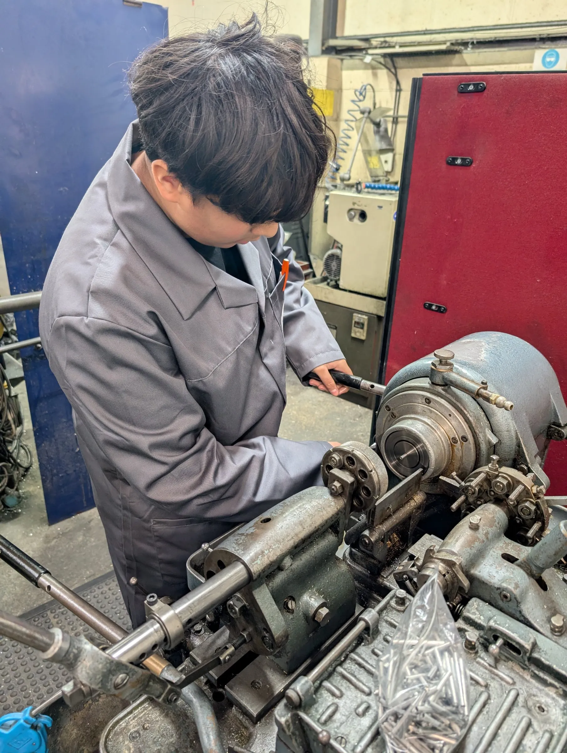 Apprentice working at a Britan repetition lathe