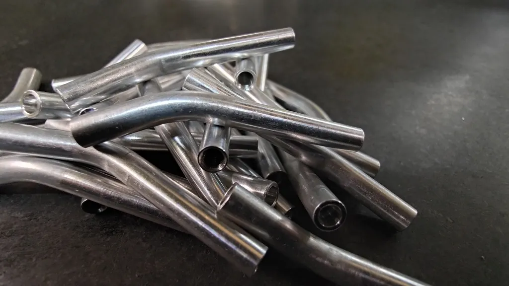 Batch of CNC machined and bent aluminium tubes